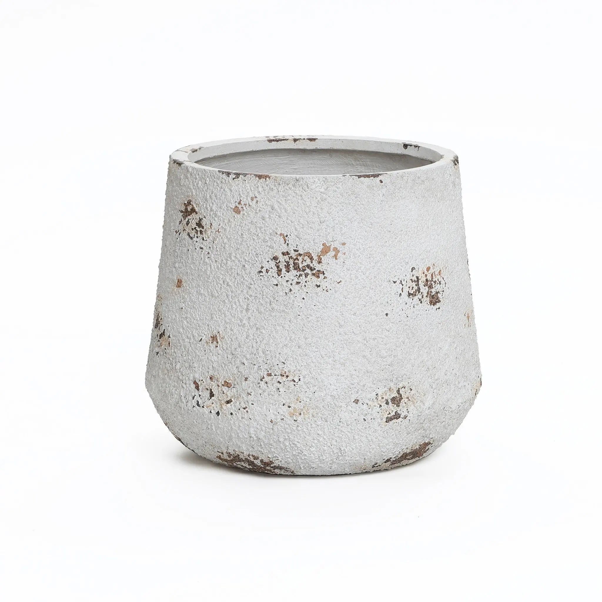 A rough-textured, cylindrical concrete planter with a tapering base showcases a weathered, vintage minimalist style and brownish spots.