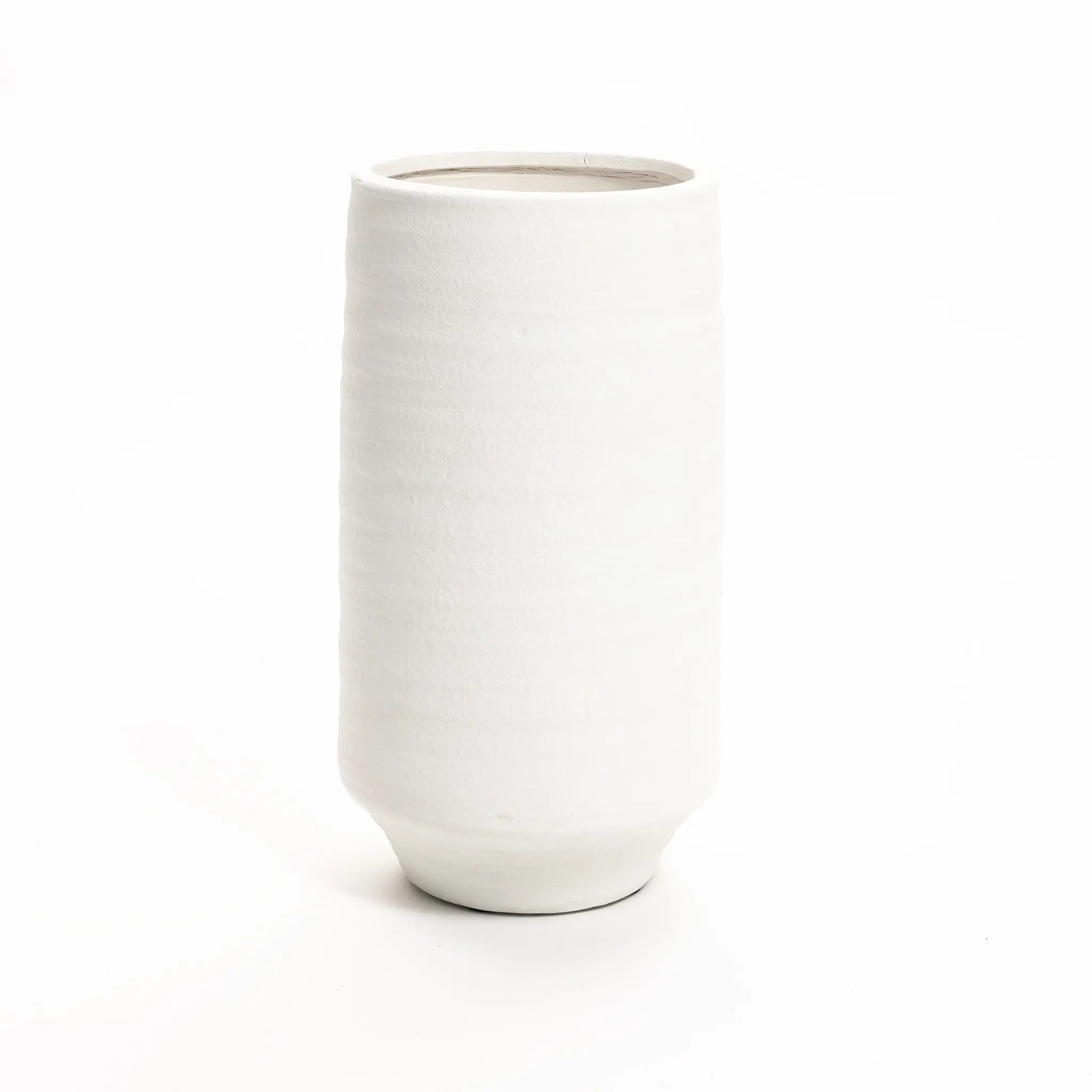 A plain, white terracotta vase stands upright against a white background, showcasing its classic cylindrical form.