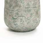 A close-up of the LuxenHome Rustic Multi-Color Cement 14-Inch Round Planter features wavy, raised patterns. Its light grey with green accents on ridges elevates the intricate design, set against a plain white background for emphasis.