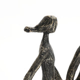 A black, abstract sculpture, crafted from modern resin, features a humanoid figure with an elongated snout-like head against a white background—a striking home decoration piece.