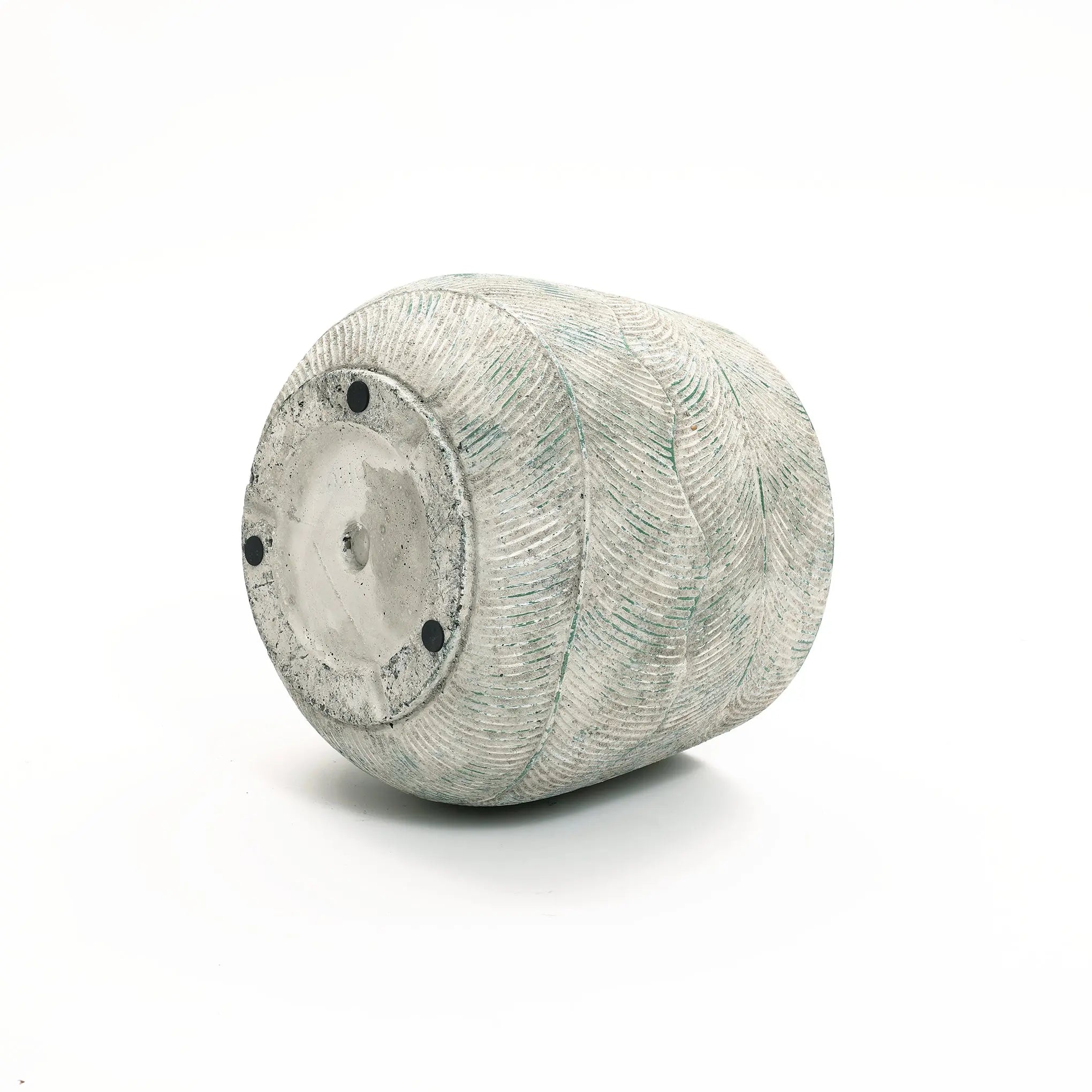 A LuxenHome Rustic Multi-Color Cement 18.3-Inch Round Planter, with textured wavy horizontal lines in gray and light green, reminiscent of a ceramic vase, lies on its side against a white background. It features a circular flat bottom with three small black feet.