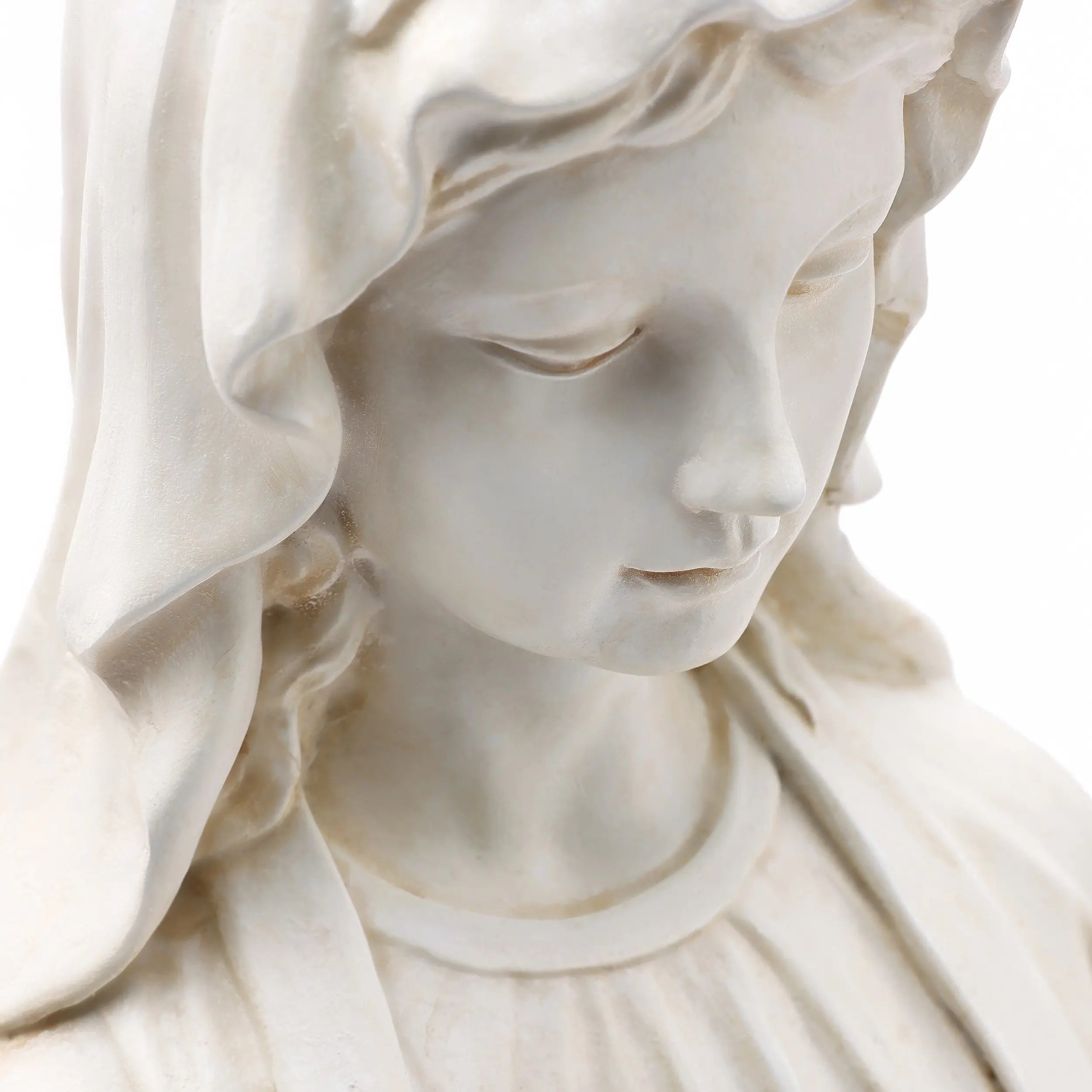 Close-up of a Mary statue in durable magnesium oxide, depicting a serene woman with downcast eyes, wearing a hooded robe and featuring a vintage ivory finish.