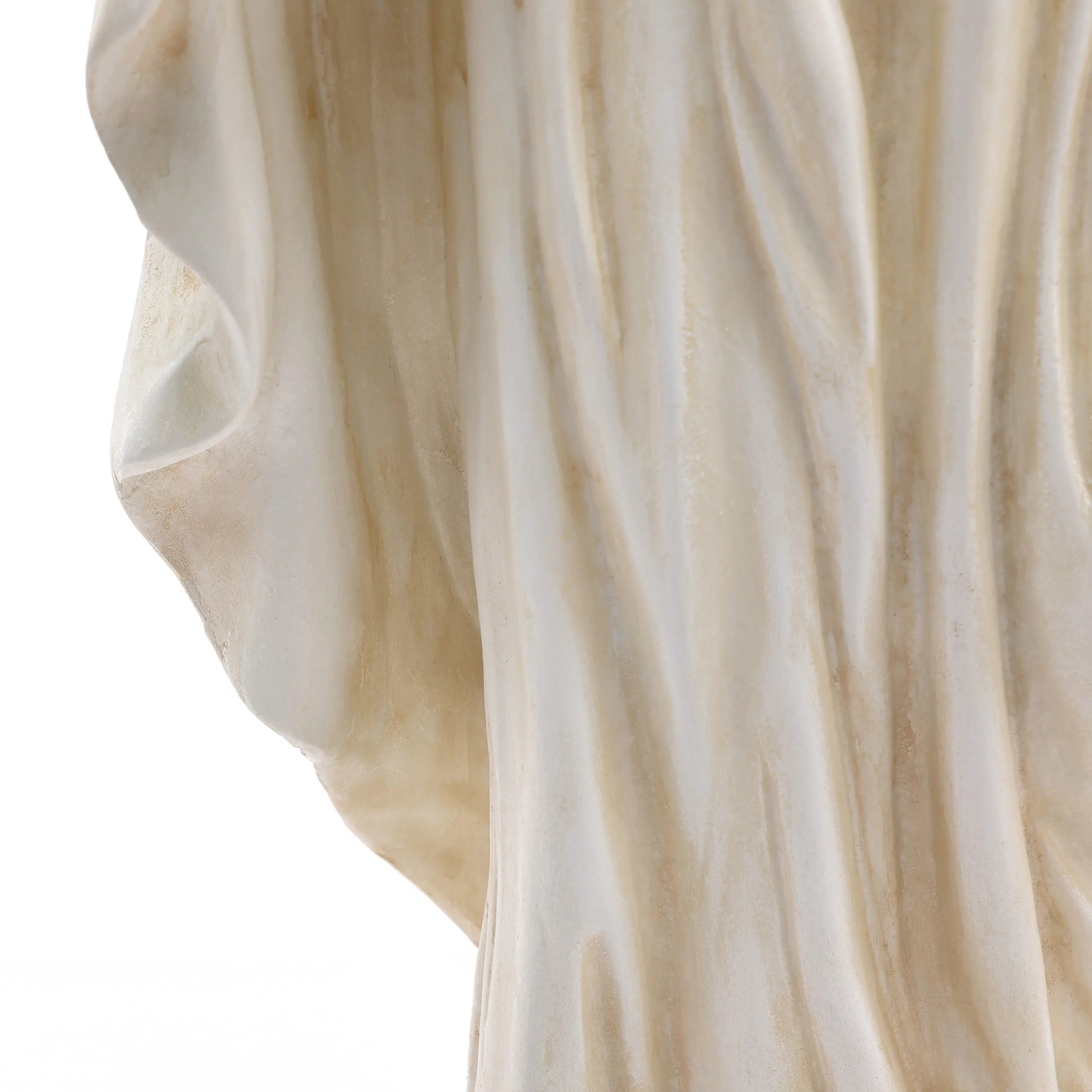 Close-up of draped, cream-colored fabric with soft folds and a slightly textured surface, reminiscent of a vintage ivory finish, set against a white background.