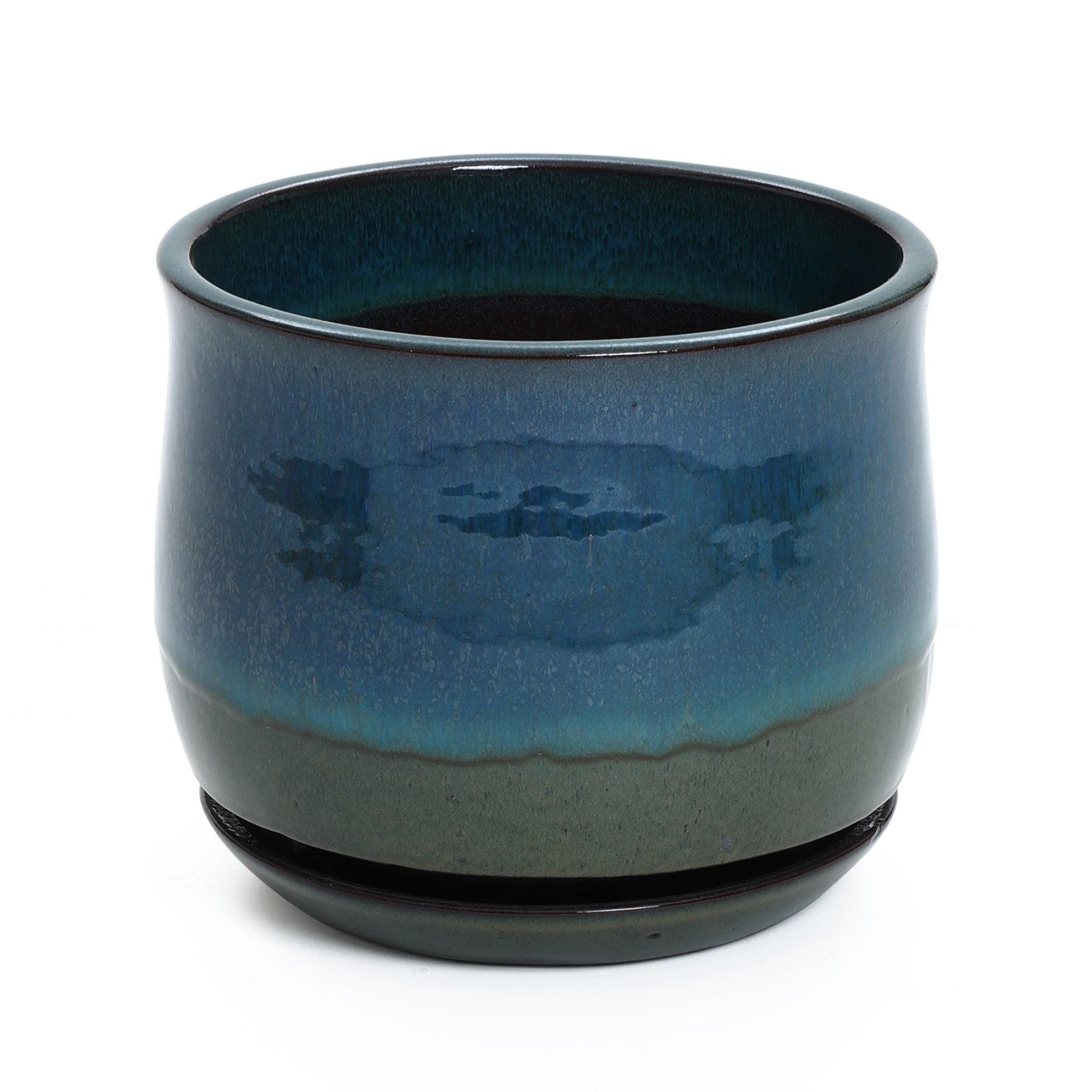 A round, glossy blue-green ceramic planter with drainage holes, it showcases a dark base and comes with a circular saucer at the bottom.