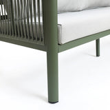 Corner of a green metal outdoor loveseat sofa with plush light gray cushions and rope accents on the armrest, featuring a durable aluminum alloy frame, set against a white background.