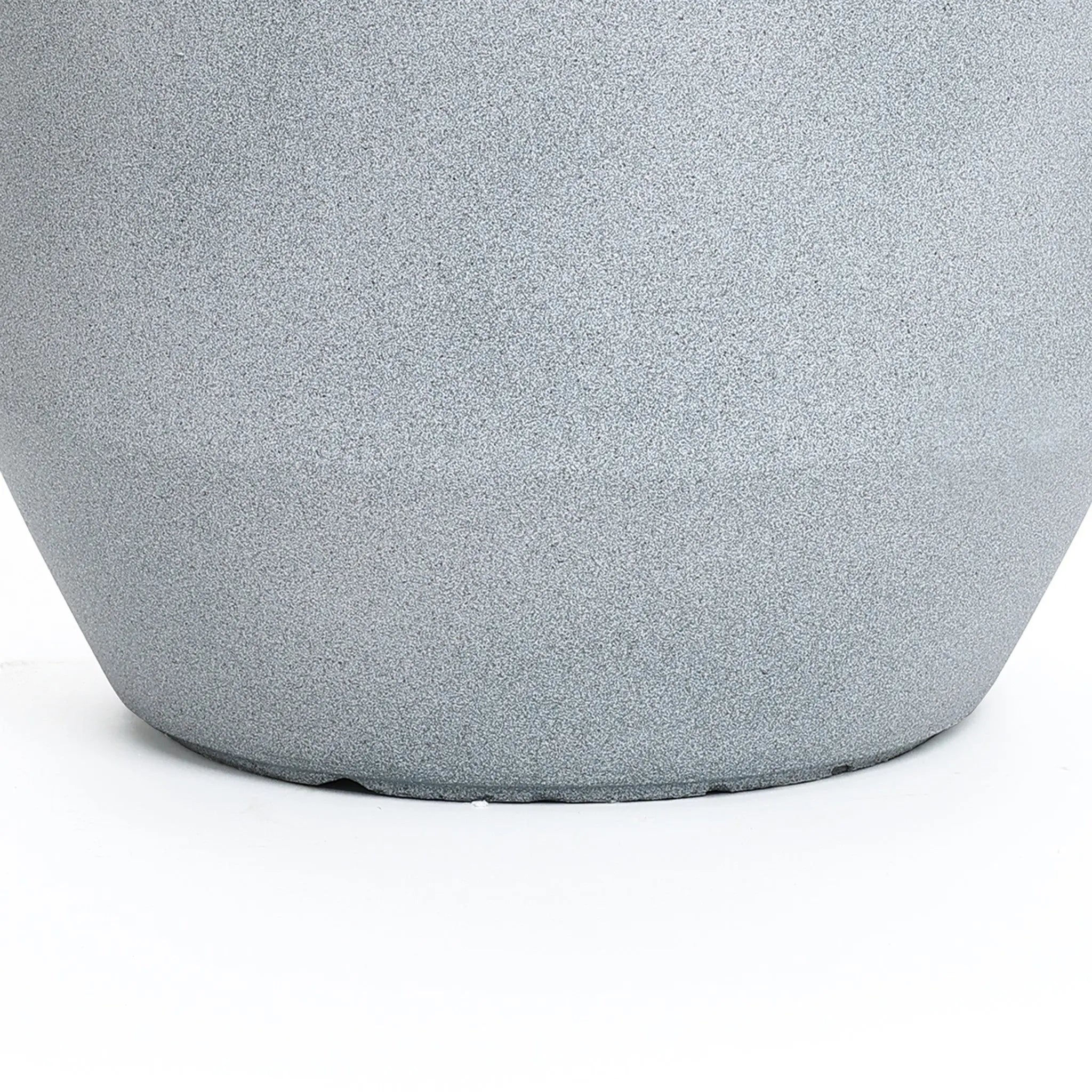 Close-up of the lower half of a textured gray planter on a white surface, perfect for both indoor and outdoor decor.