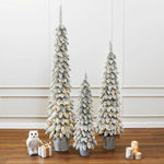 pre-lit-snow-flocked-small-christmas-tree-set-of-3-on-the-ground-with-gift-box-and-candle