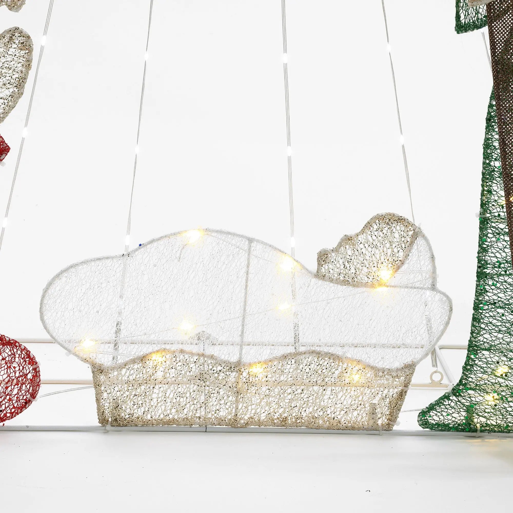 A wireframe nativity scene featuring a glowing baby Jesus figure illuminated by small LED bulbs, set against a white background. This enchanting Christmas decoration is beautifully complemented by the radiant presence of the North Star.