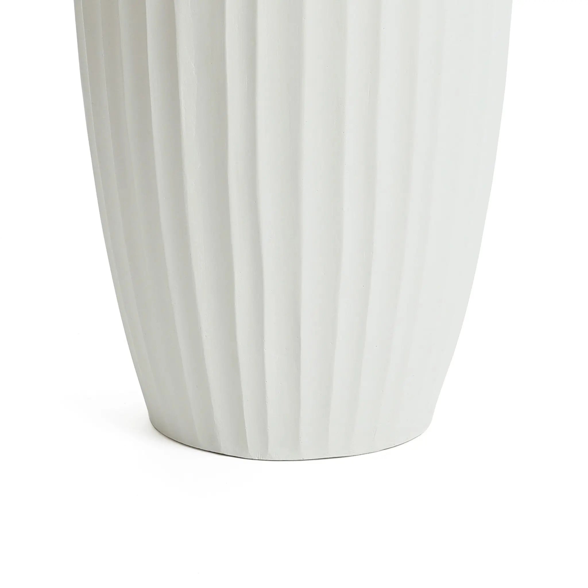 Close-up of the base of a tall, white ceramic vase with vertical ridges, embodying modern abstract sculpture. This decorative piece seamlessly enhances any contemporary home decor against its pristine white background.