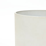 Close-up of a light beige, cylindrical ceramic planter against a white background, showcasing the smooth texture and precise edge. This contemporary piece highlights its durable design, perfect for adding elegance to any space.