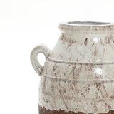 Close-up of a Rustic cream and brown terracotta urn vase with handles by LuxenHome, set against a light speckled background. Its round body and narrow neck highlight its artisanal craftsmanship and rustic elegance.