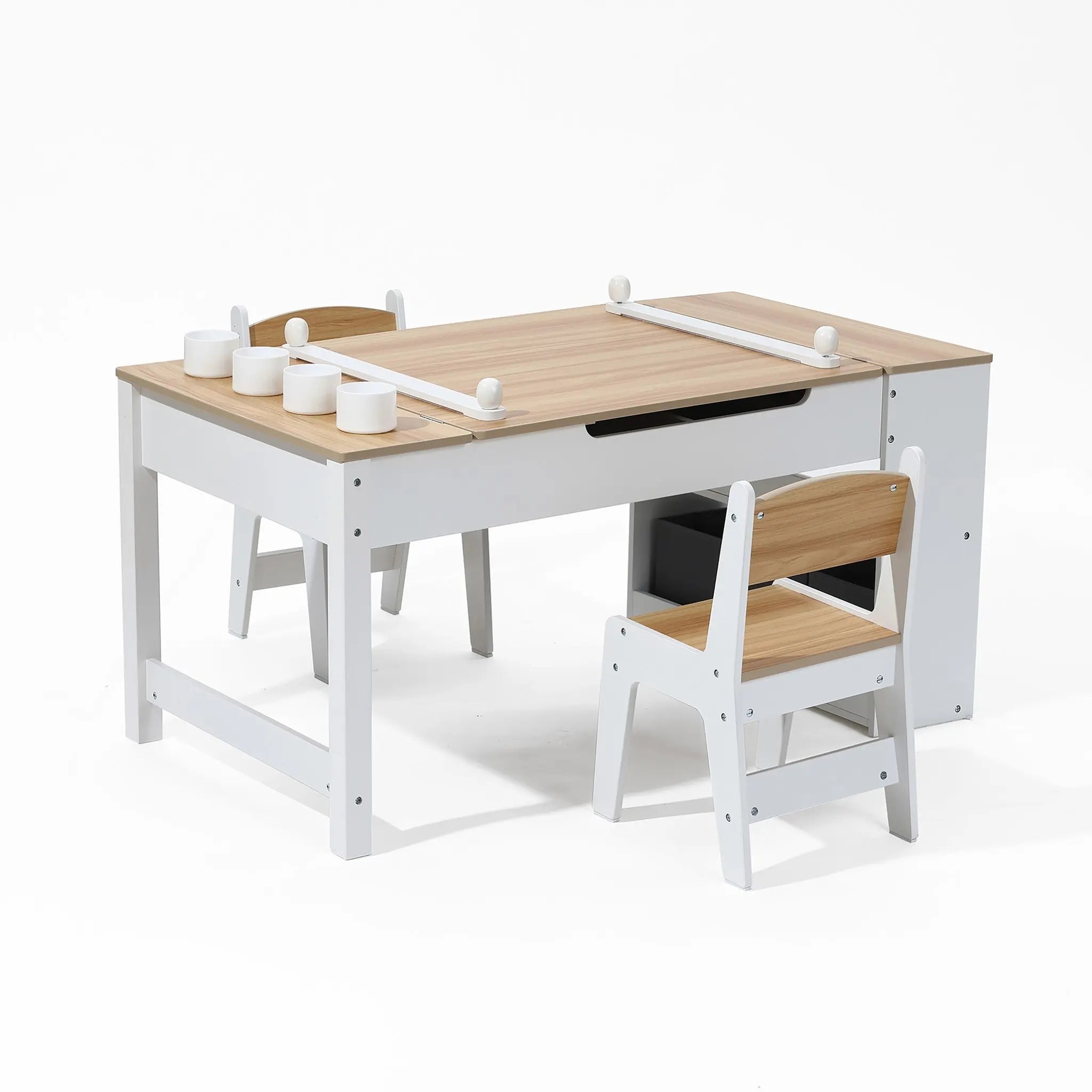 The Activity Children Table with Storage Bookcase and 2 Chairs Set by LuxenHome features light wood surfaces and white frames, offering a built-in tabletop track for toy vehicles. Its minimalistic design suits creative projects in playrooms or nurseries.