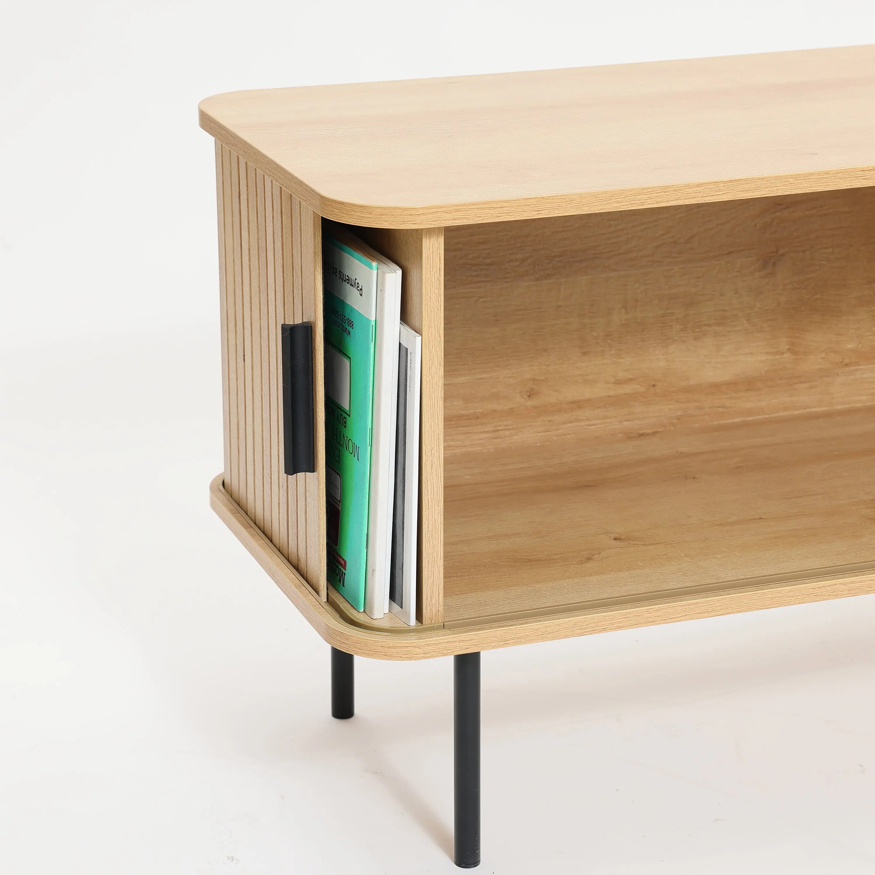 This wooden cabinet, featuring open shelving and a side section for books, stands elegantly on black metal legs. With its design reminiscent of an oak TV stand, it offers ample space to accommodate a 65-inch TV while maintaining a stylish appearance.