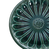 Green ceramic plate with a flower pattern radiating from the center, enhanced by petal-shaped ridges and a glossy finish, perfect for sprucing up your outdoor space or serving small treats beside your garden birdbath.