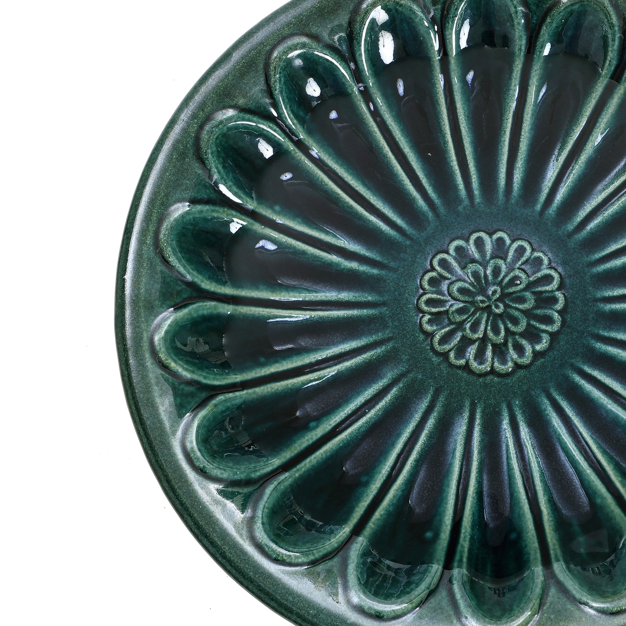 Green ceramic plate with a flower pattern radiating from the center, enhanced by petal-shaped ridges and a glossy finish, perfect for sprucing up your outdoor space or serving small treats beside your garden birdbath.