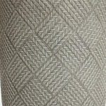 Close-up of a textured surface featuring a pattern of interwoven diamond shapes formed by intricately braided grey rope, reminiscent of the sleek lines found in modern minimalist design.