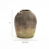 A rustic terracotta vase with a single handle, measuring 11 inches in height and 9.6 inches in diameter, boasts a handcrafted weathered finish. Perfect as an indoor and outdoor urn, it adds timeless charm to any setting.