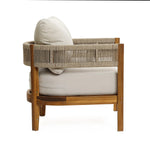 A Rope Sides Armchair crafted from acacia wood with weather-resistant beige cushions and a woven rope backrest, shown from the side against a white background.