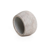 A sleek, round, slanted, striped ceramic planter with a wide opening rests on a flat surface against a plain white background, showcasing its minimalist design.
