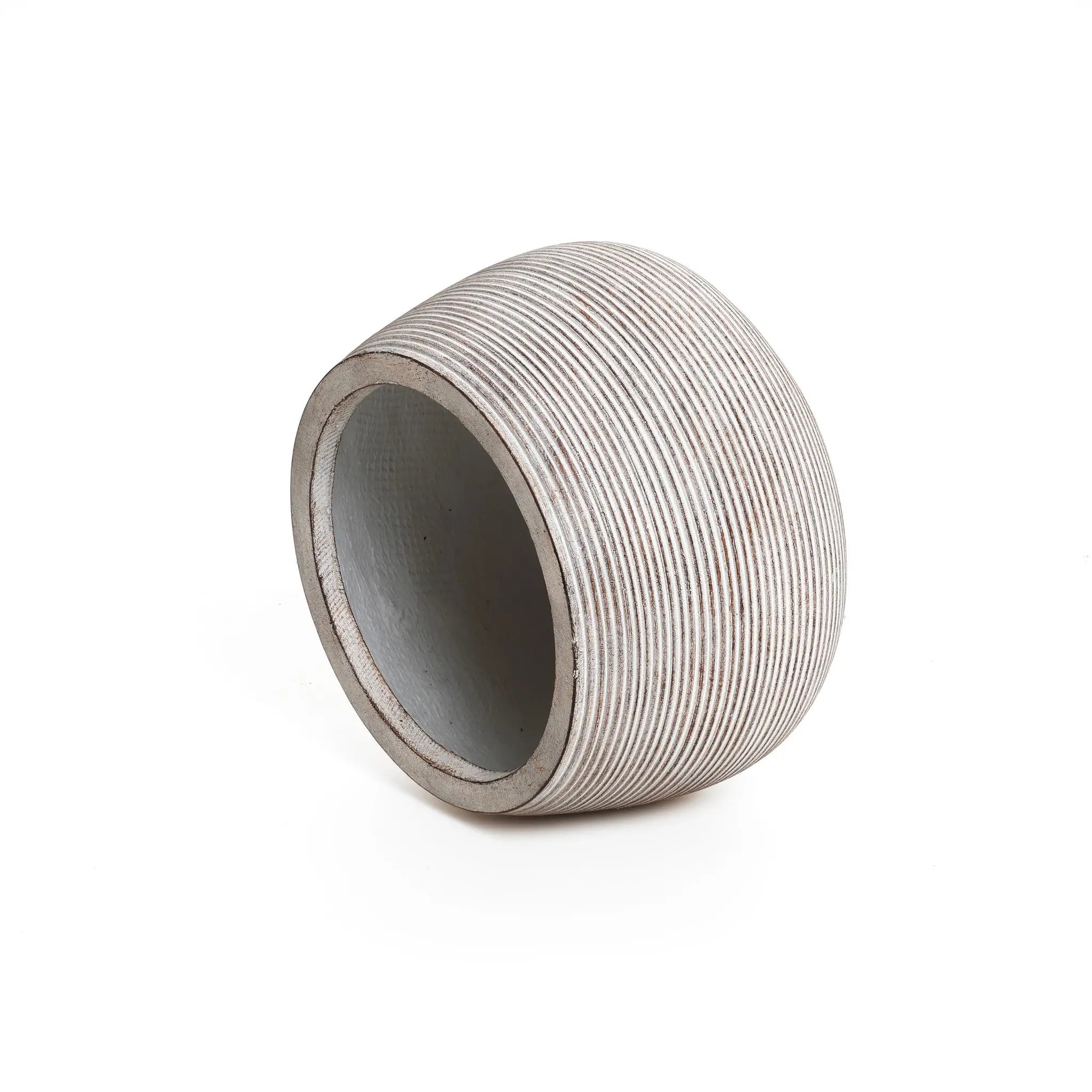 A sleek, round, slanted, striped ceramic planter with a wide opening rests on a flat surface against a plain white background, showcasing its minimalist design.