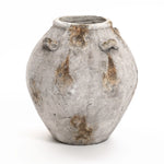 A gray, weathered clay pottery vase with three small handles and a rustic, textured appearance captures the charm of a handcrafted vintage vase. Perfect as versatile home decor, it adds a timeless touch to any setting.