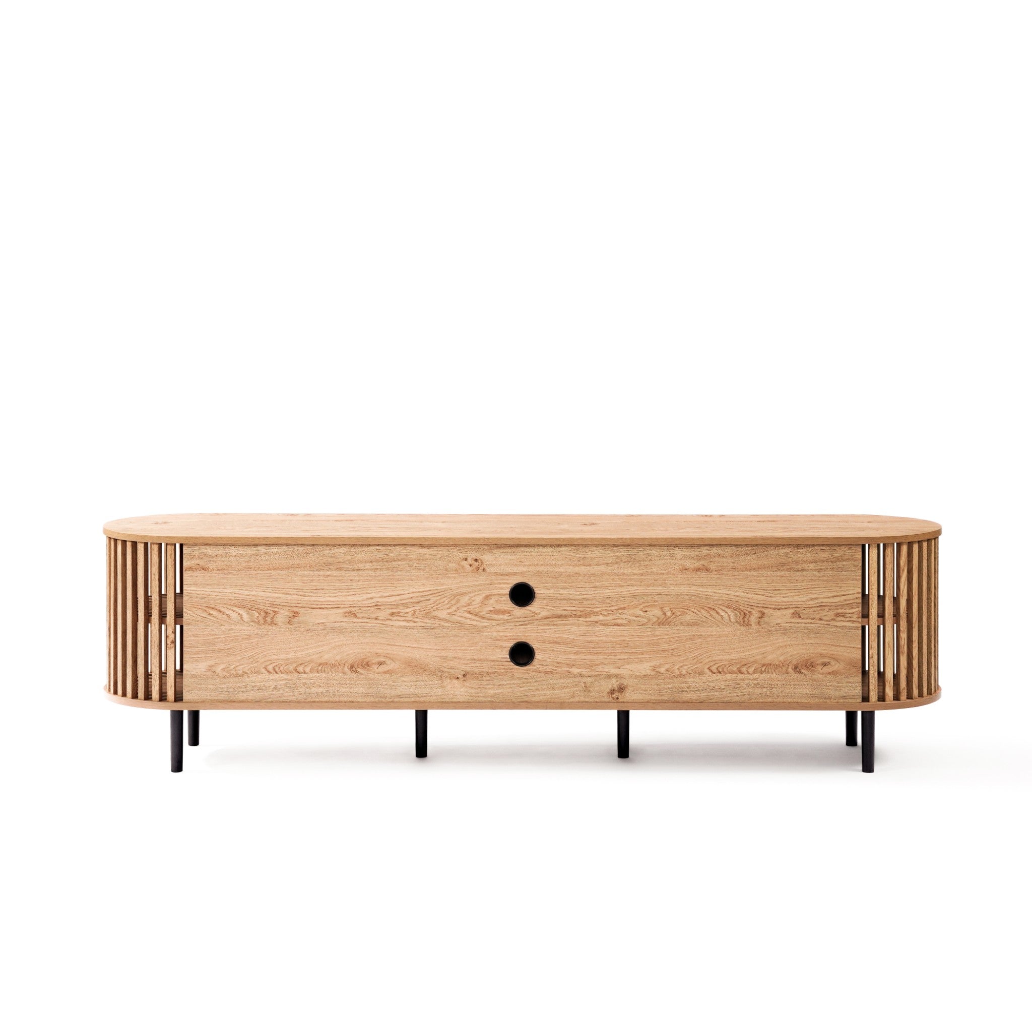 A mid-century modern TV cabinet crafted with a wood finish features rounded edges, two round black handles on drawers, and a vertical slat design on the sides. It rests stylishly on black metal legs, seamlessly blending classic and contemporary aesthetics.