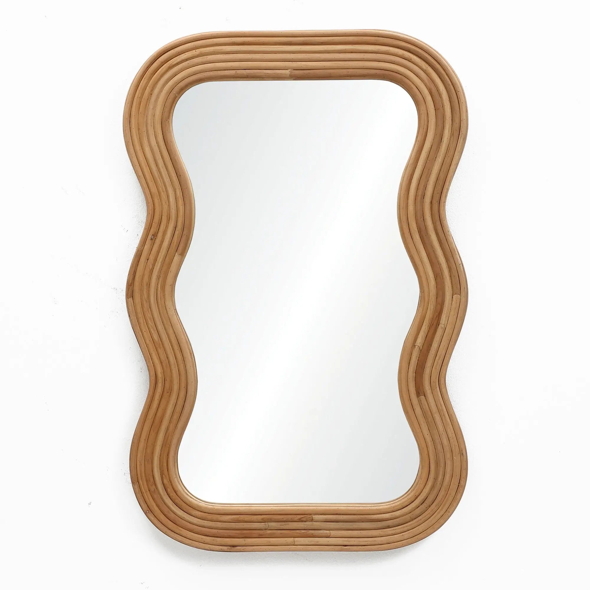 A wavy rectangular wall mirror with a sleek cork wood frame is mounted on a white wall, adding a modern vibe to the space.