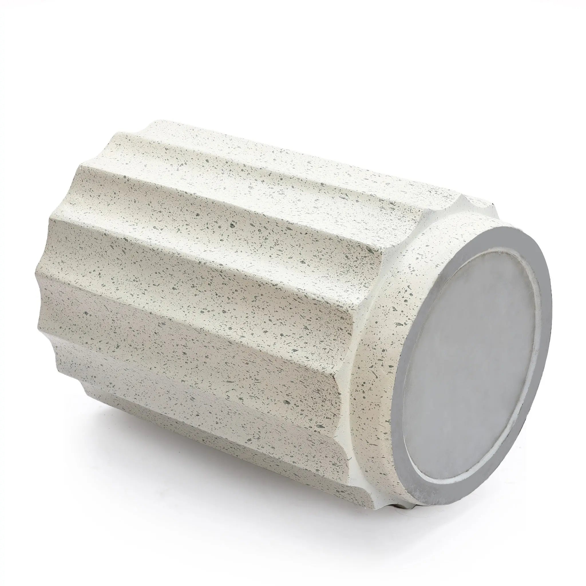 A cylindrical, light gray cement object with vertical grooves lies on its side against a white background—perfect as modern side table or outdoor decor.