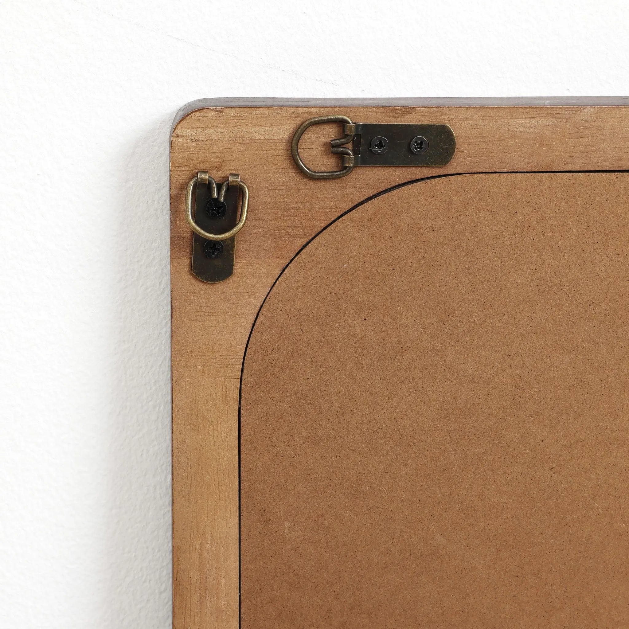 Close-up of the back corner of a rubberwood frame, featuring metal hanging hardware and brackets. Perfect for any home decor, this versatile piece functions beautifully as a wall mirror or picture display.