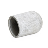 A concrete cylinder with a gray and white speckled texture lies on its side against a plain white background, showcasing a modern design.