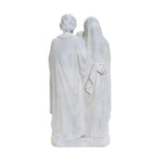 Back view of two white marble statues, reminiscent of a Holy Family statue, standing side by side with one gently draping an arm around the other. Both cloaked in elegantly flowing robes, this piece captures the essence of religious decor in a serene display.