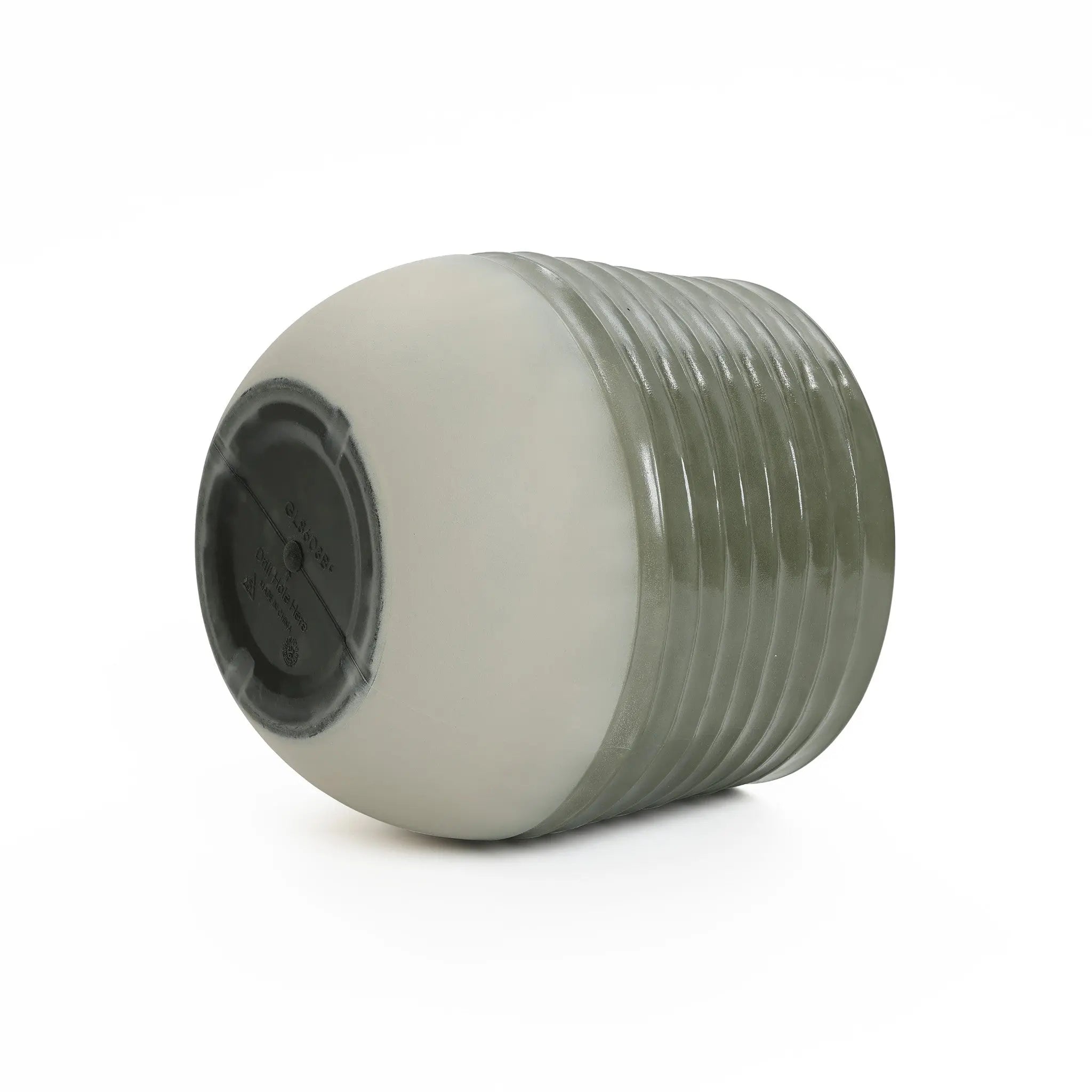 A ribbed, cylindrical planter with a smooth, light-colored base is shown from a low angle against a plain white background. Designed for indoor and outdoor environments, it blends functionality with style effortlessly.