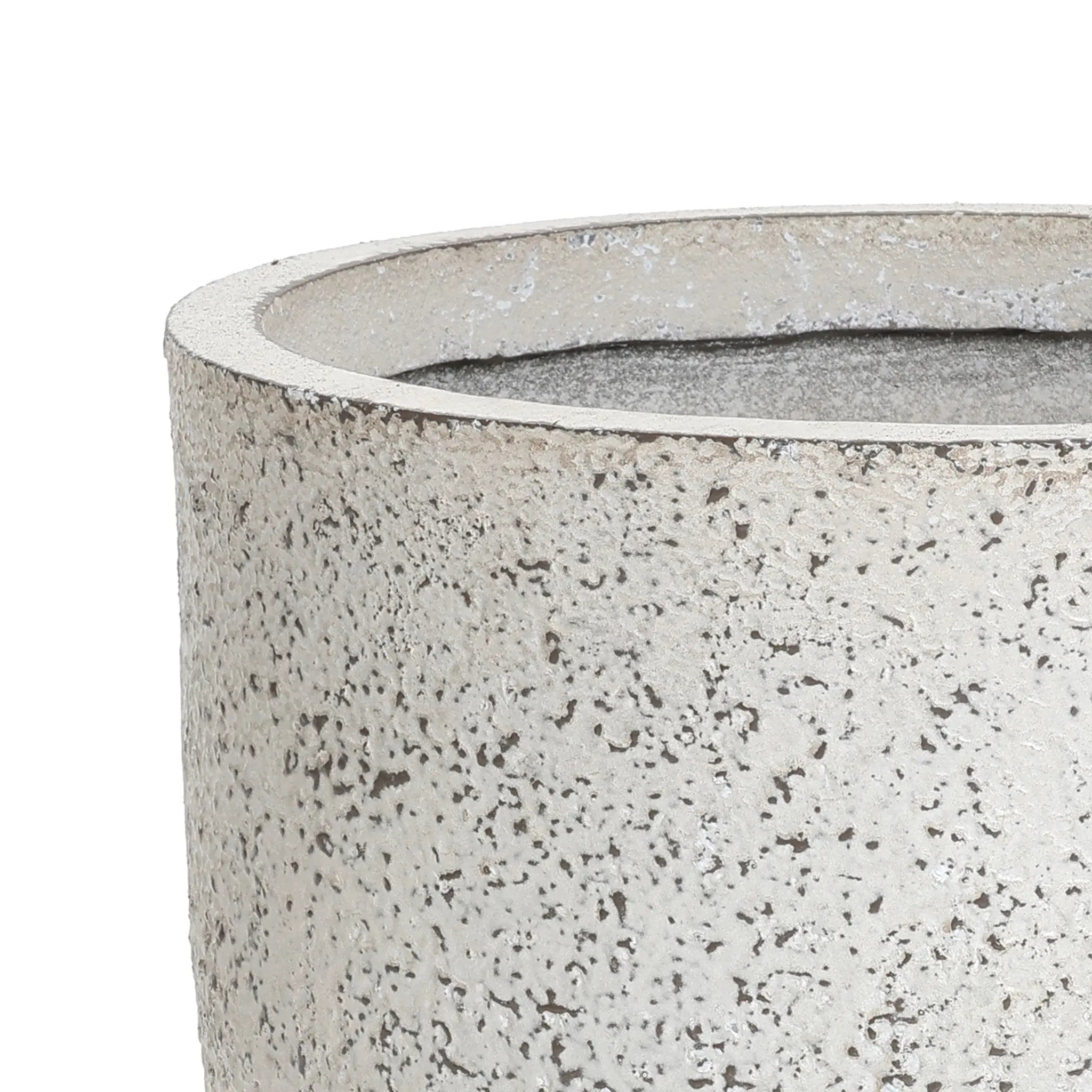 Close-up of an antique charm planter with a textured, light-gray concrete surface and a round, open top, showcasing its rough, speckled finish.