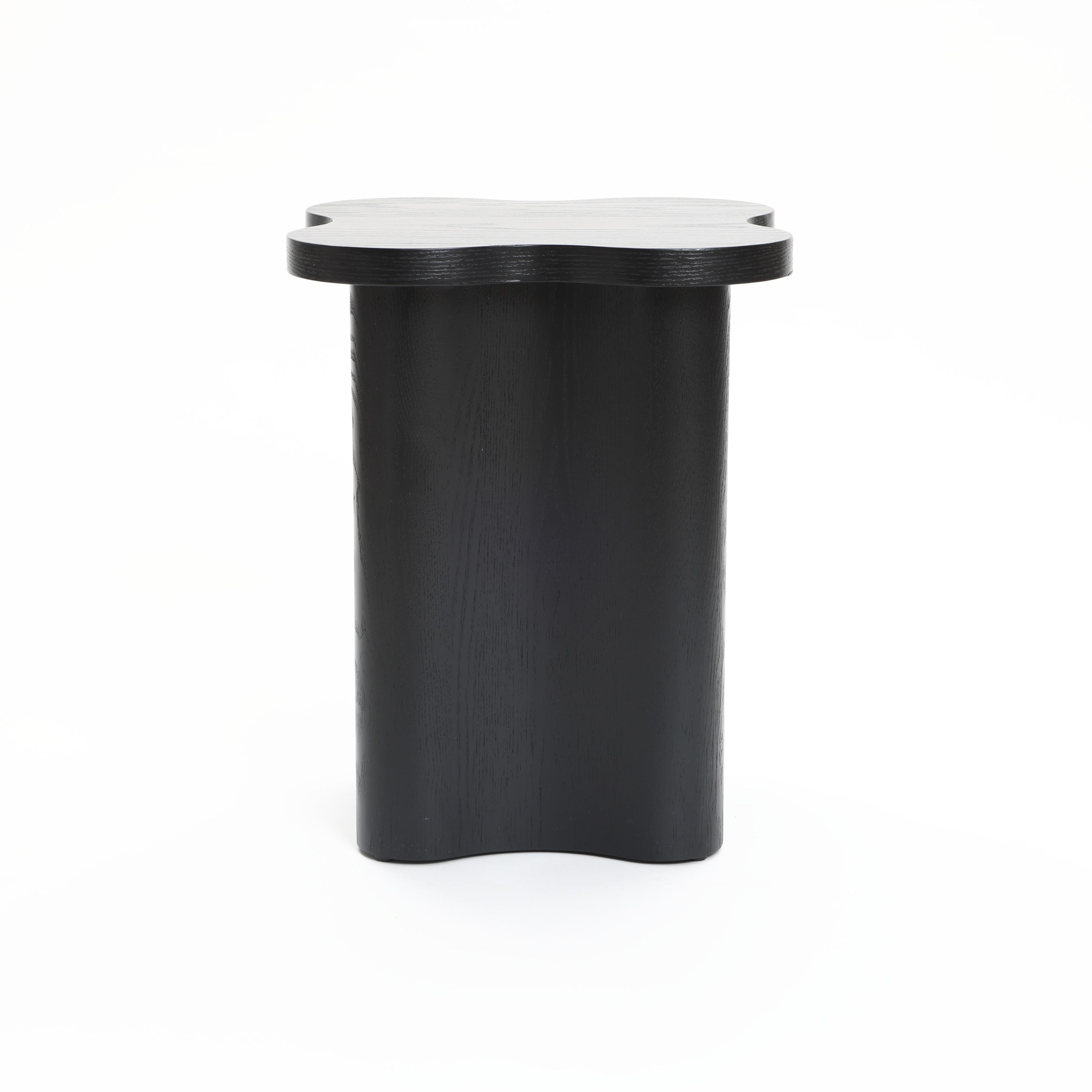 A modern-style side table crafted from premium MDF wood, featuring a striking black cloverleaf shape with a matching base, photographed against a plain white background.