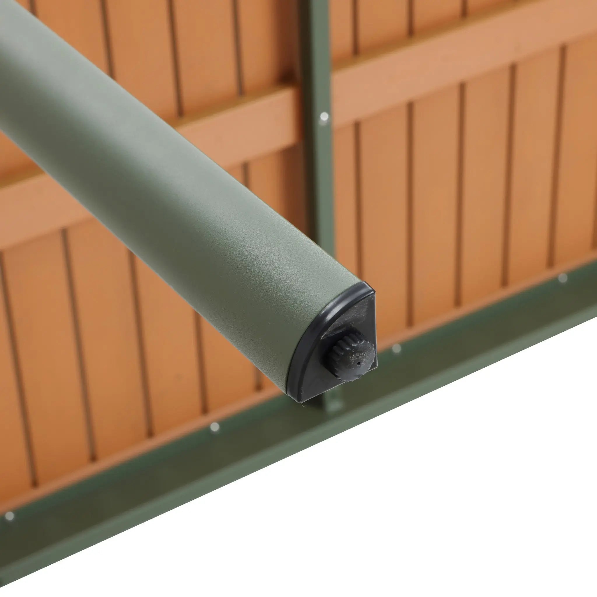 Close-up of a green roller shade with a durable aluminum alloy frame mounted on a wooden fence.