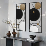 A modern abstract wall decor set features two-piece designs with circular patterns in black, white, and gold. They elegantly hang above a marble console table adorned with ceramic vases and a decorative bowl.