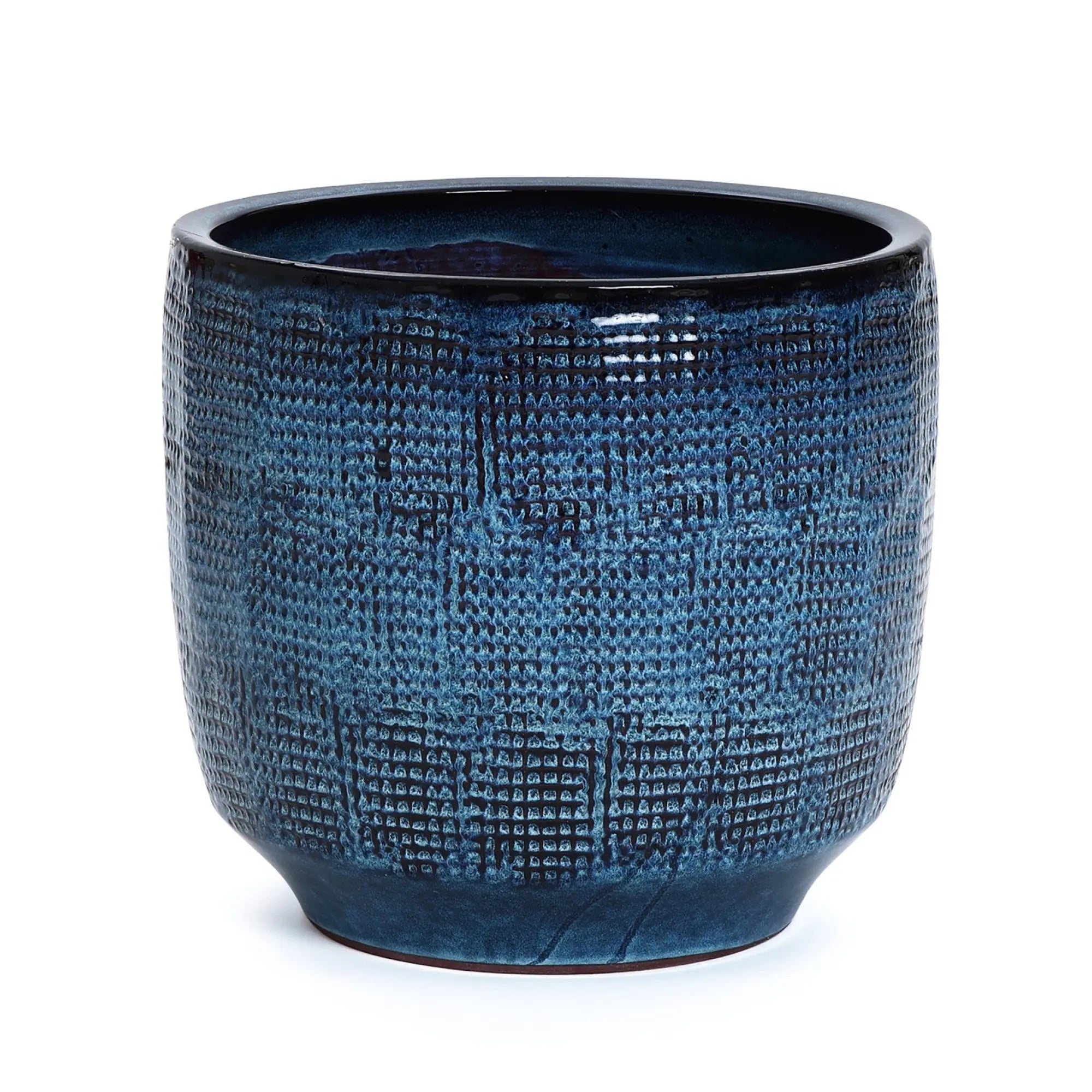 The LuxenHome Ocean blue glazed ceramic planter, standing 13.98 high, features a textured dark blue finish with intricate patterns for a woven look. Its slightly irregular cylindrical shape and glossy surface elegantly reflect light, making it a sophisticated decor addition.