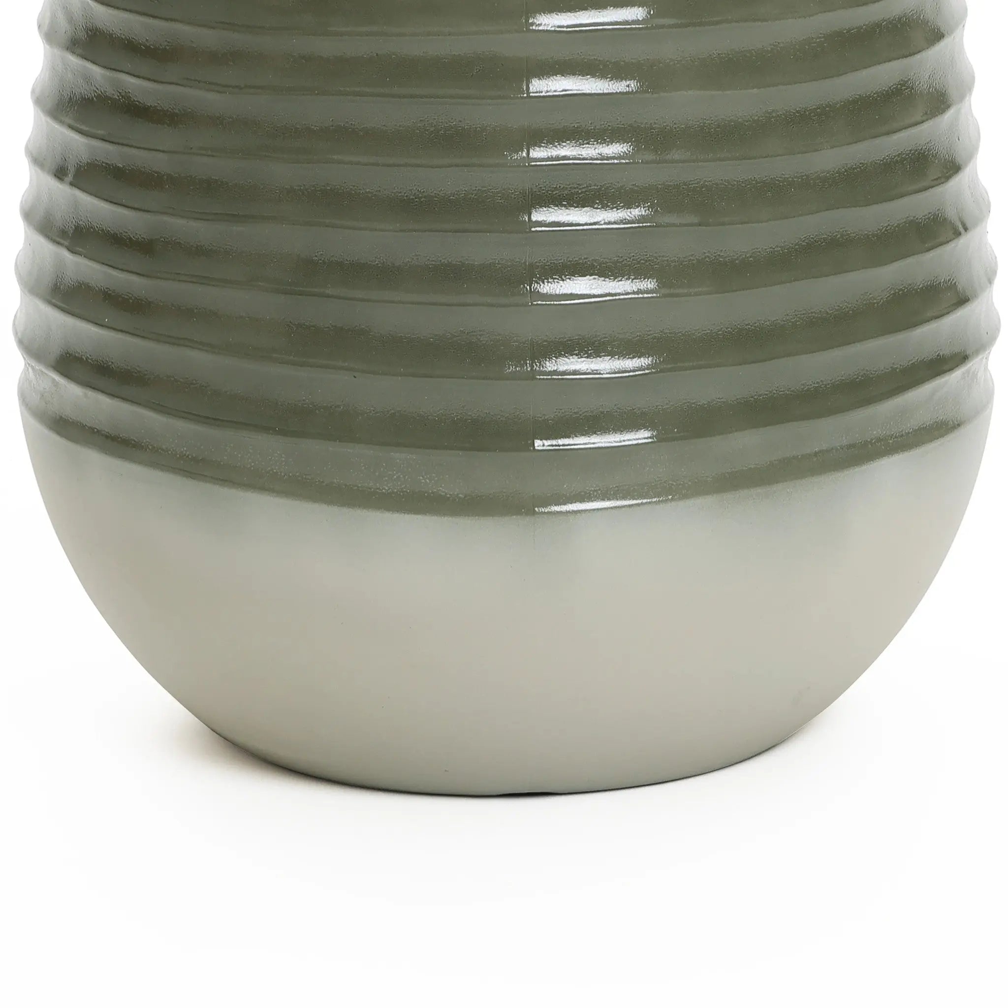 Close-up of a textured, cylindrical ceramic vase with a ribbed upper half and smooth lower half, in shades of green and white. Perfect as an elegant planter, it seamlessly complements both indoor and outdoor environments.