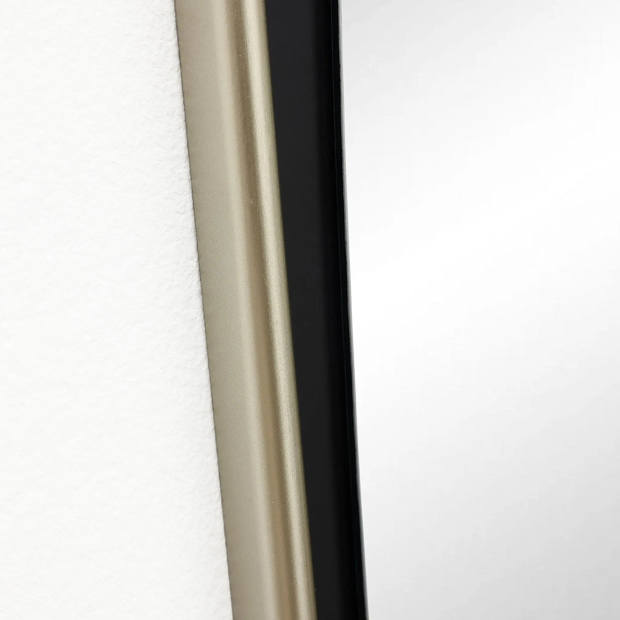 Close-up of a modern door, featuring a beige frame edge on the left and a sleek black frame edge on the right. The design adds a contemporary touch, perfect for complementing any space.