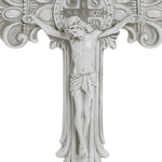 White crucifix with a detailed depiction of Jesus on the cross, emblematic of the Christian faith, featuring ornate decorations and a circular emblem with letters above. Perfect for religious occasions.