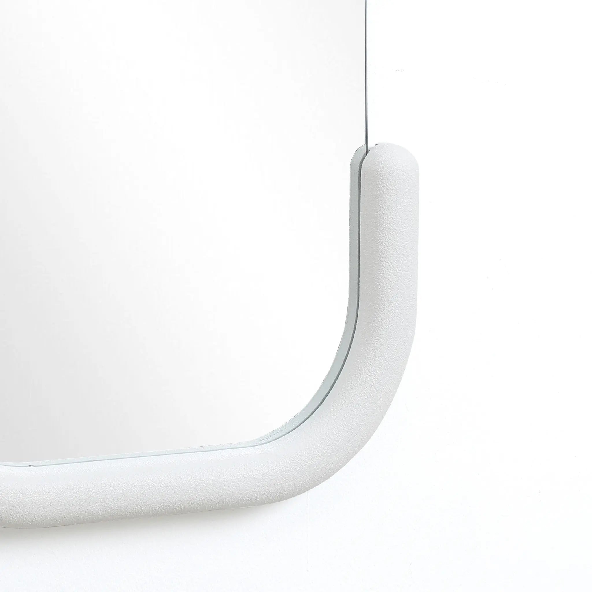 Experience modernist elegance with this decorative wall mirror, featuring a minimalist design and a C-shaped silhouette. Its curved, light gray frame adds a subtle touch against the plain white background.