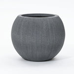 A round, ribbed gray planter pot crafted from durable polyethylene with a wide opening, set against a plain white background. This modern planter is UV-resistant, making it perfect for both indoor and outdoor spaces.