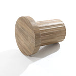 A LuxenHome fluted round side table with a dark oak finish rests on its side against a white background, boasting a smooth circular top and vertical grooves for a modern aesthetic.