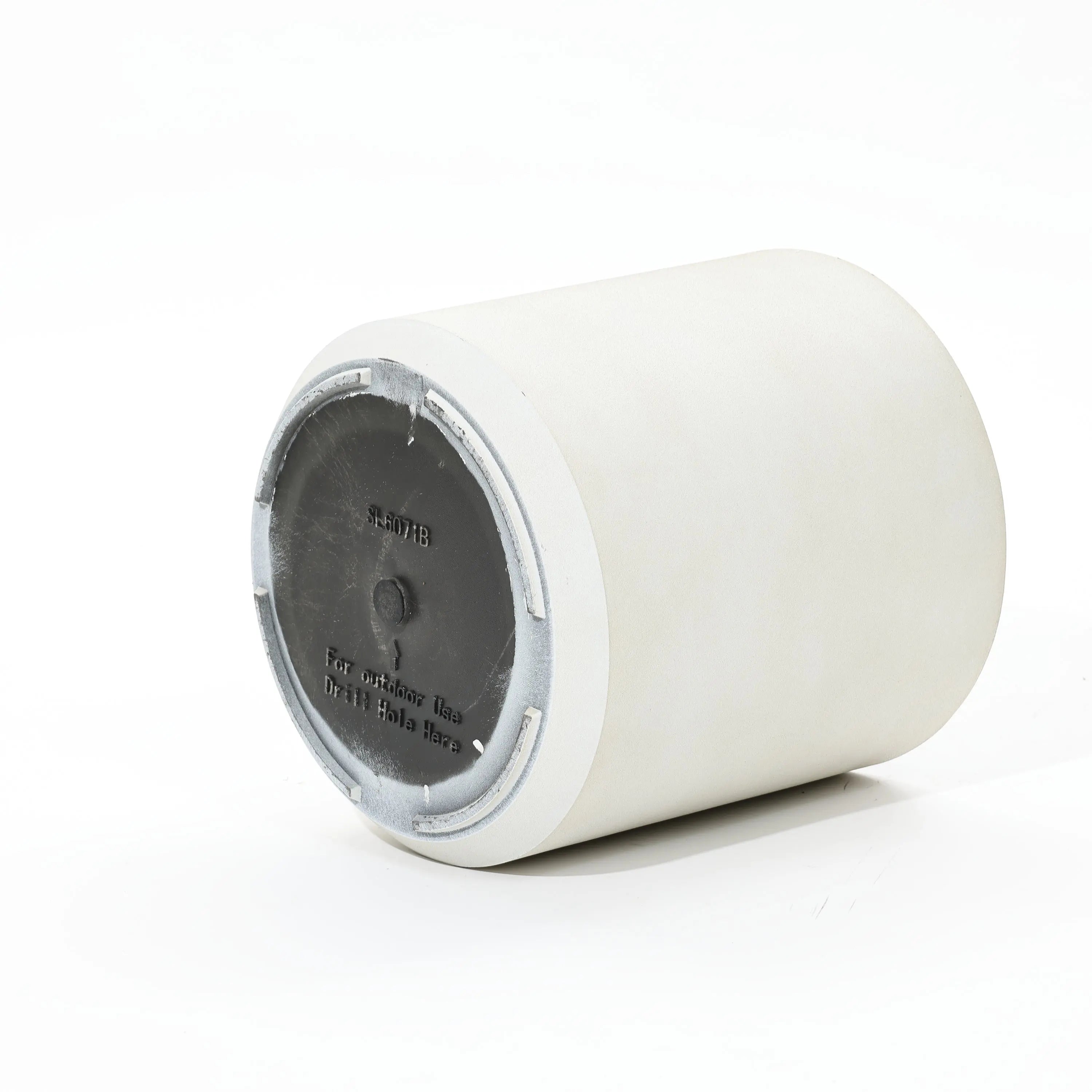 A white cylindrical planter with a gray base is shown, lying on its side. The contemporary design includes inscribed text and a notice to drill holes for durability.