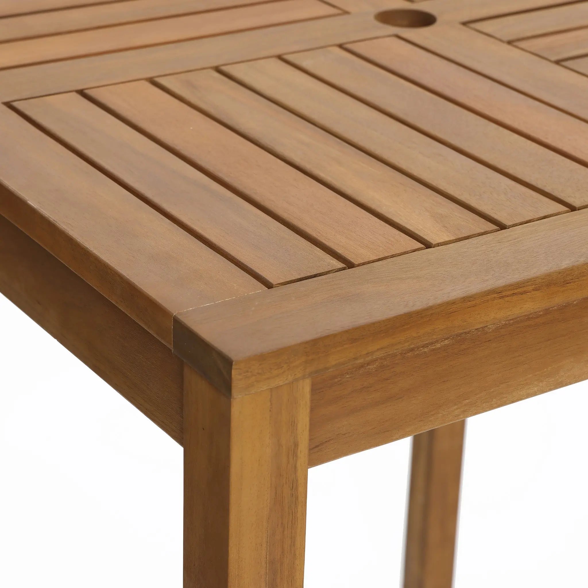 Close-up of a wooden table corner featuring a slatted design and smooth finish, crafted from FSC-certified acacia wood.