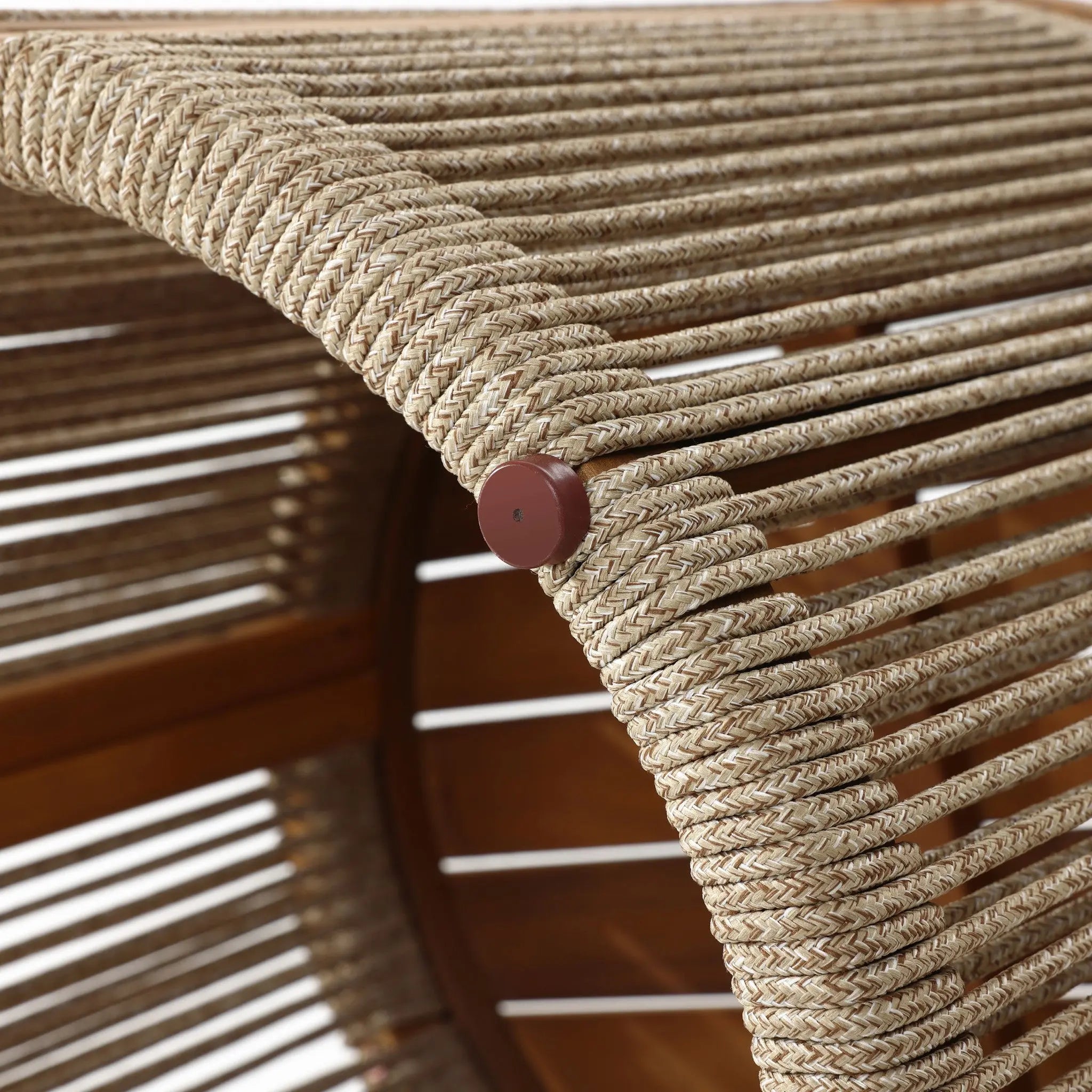 Close-up of a woven rope chair back with a wooden frame made from natural acacia wood. The light-colored, hand-woven ropes are tightly wrapped and secured with round wooden pegs.