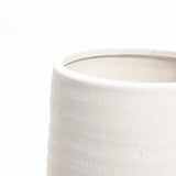Close-up of the upper portion of a textured, white terracotta vase against a plain white background, showcasing its elegant design perfect for both indoor and outdoor settings.
