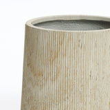 Close-up of a beige cylindrical vase with a textured, ribbed surface, perfect for creating an elegant succulent garden display.