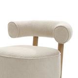 Close-up of the LuxenHome Rio upholstered cream accent chair, featuring a rounded velvet backrest and seat with light wooden legs. This elegant piece is perfect for any contemporary living space.