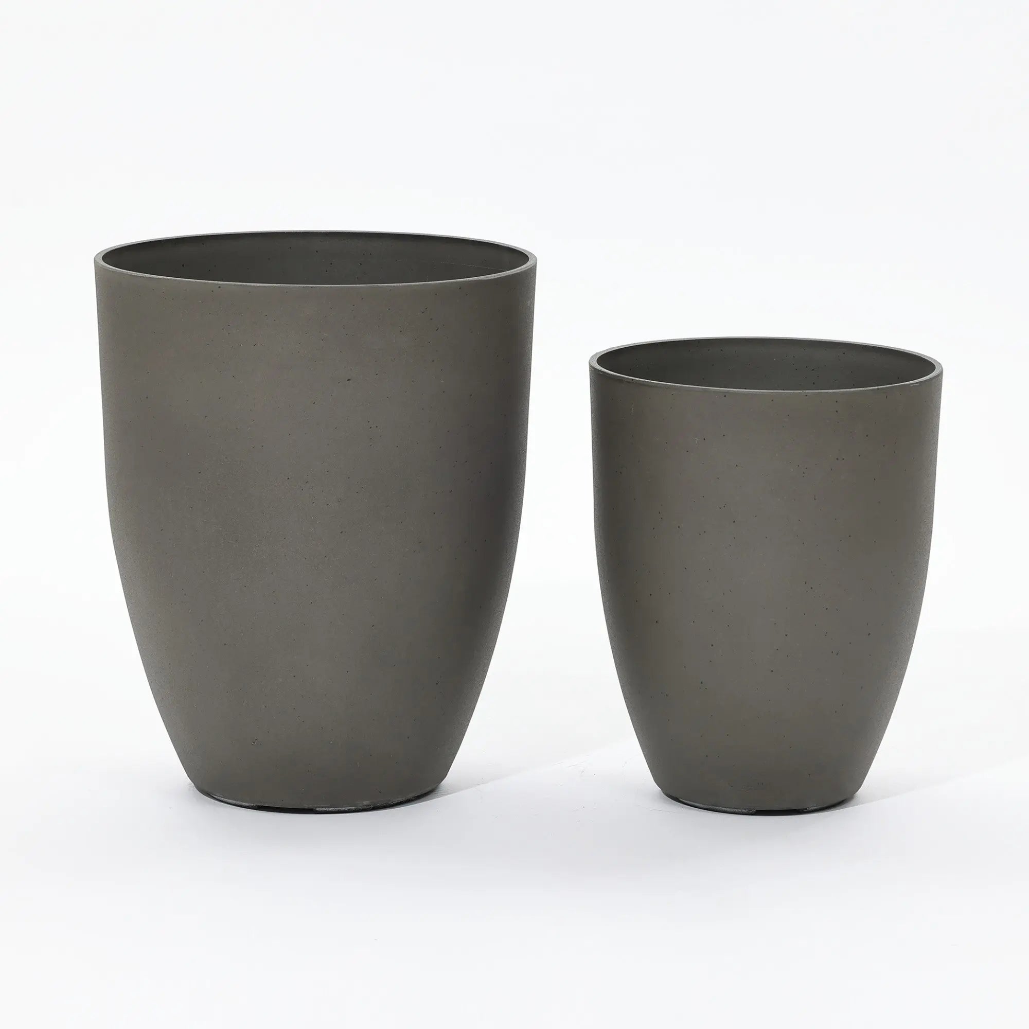 A modern planter set featuring two dark gray, cylindrical planters of different sizes is elegantly placed side by side against a plain white background.